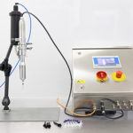 Semi-automatic benchtop dosing system for syringes with a Luer Lock attachment